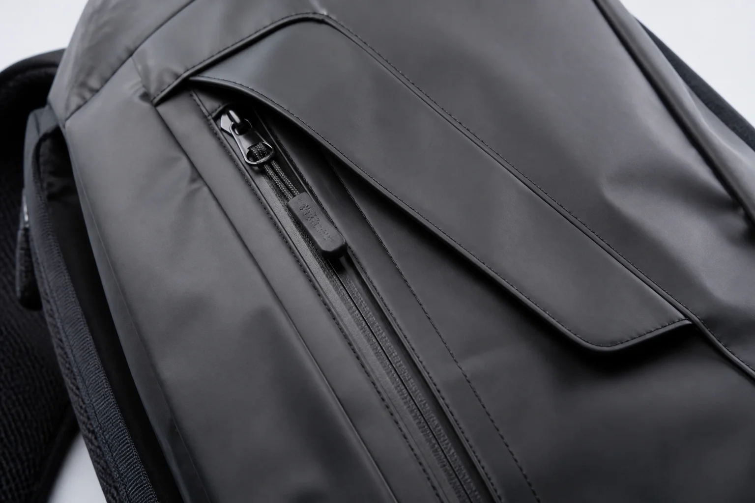 Water-resistant zipper with protective flap on a bag