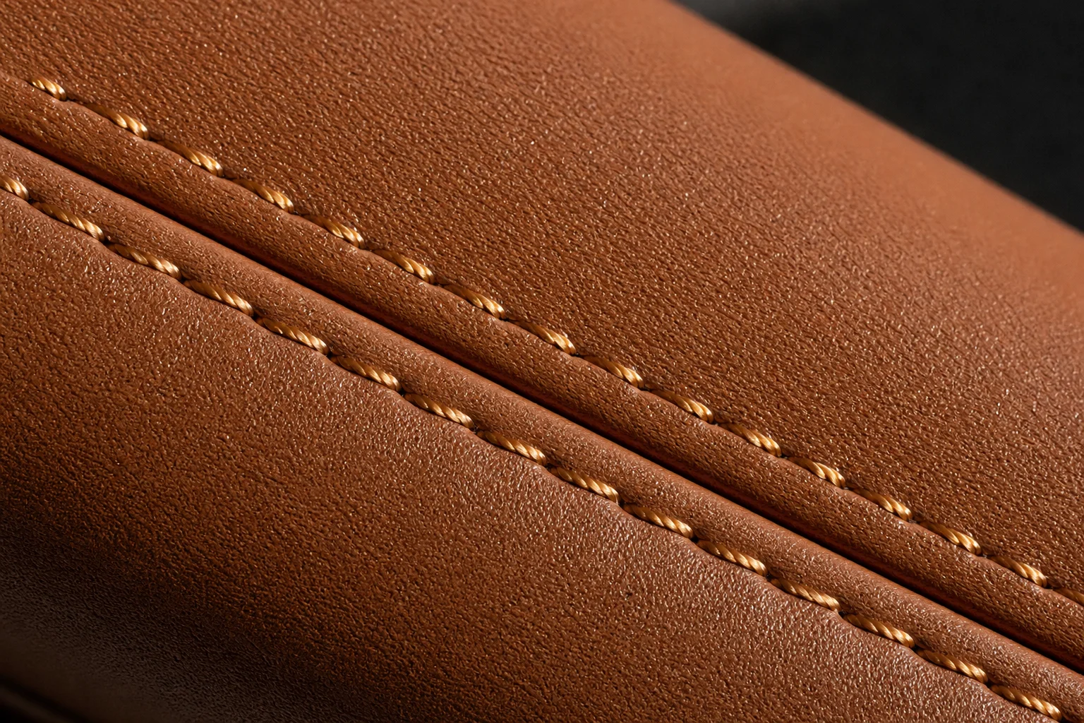 Close-up of an even double-row stitch line on a PU leather bag panel