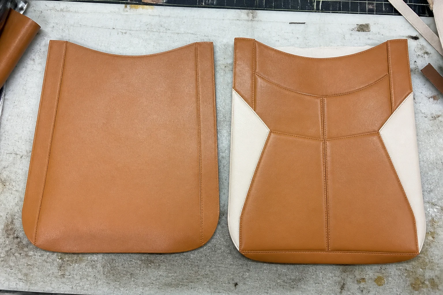 Two PU leather bag panels on a workbench comparing a simplified build with a complex multi-panel construction