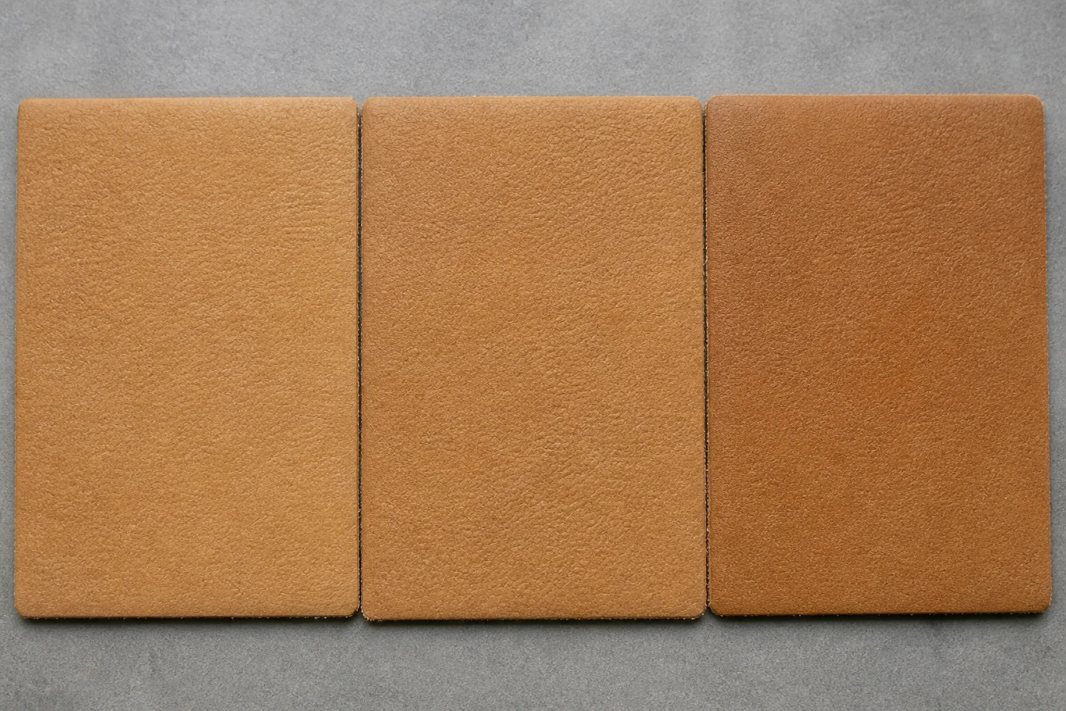 Three PU leather swatches in the same nominal tan colour showing a subtle shade difference